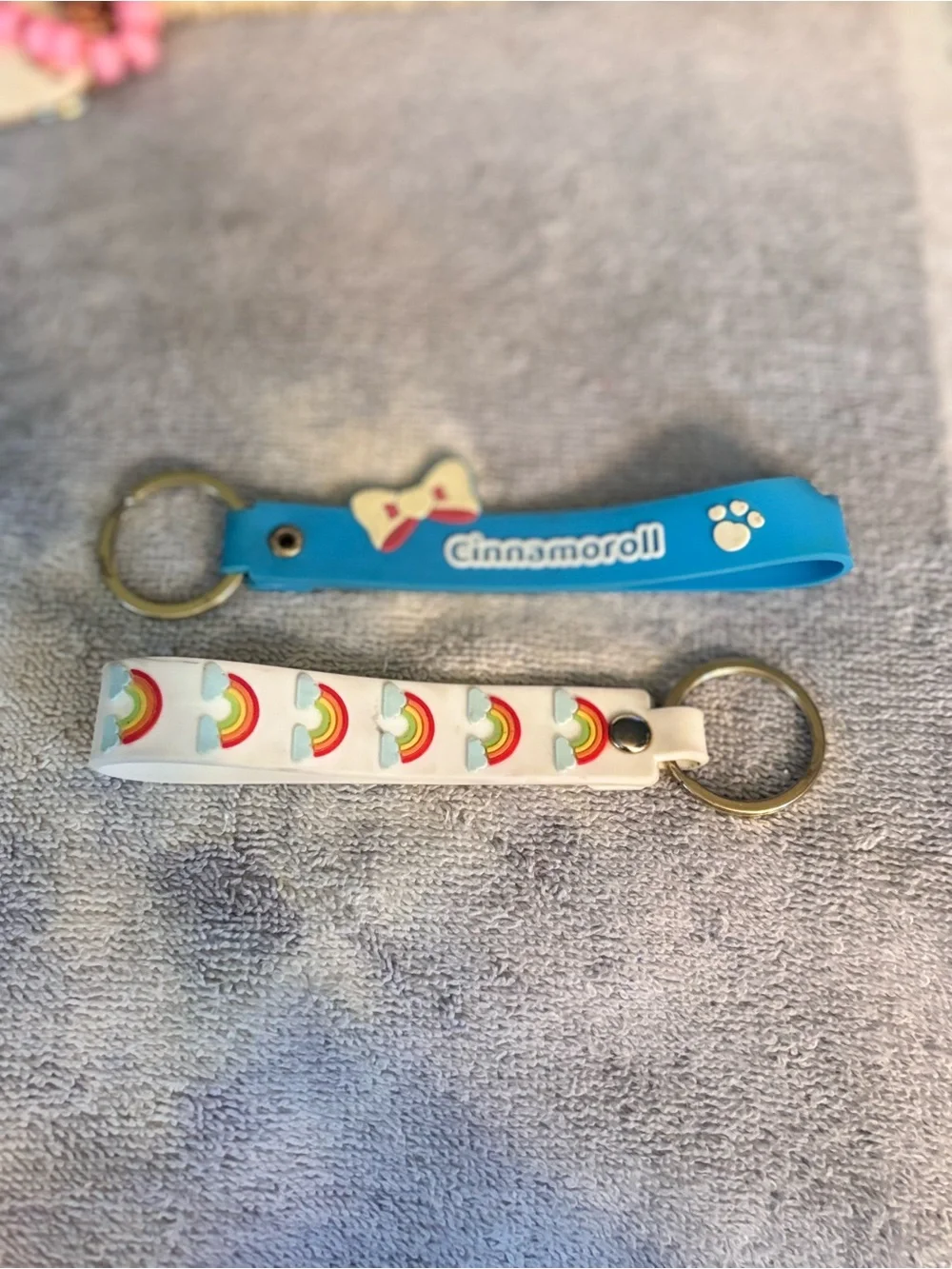 Cinnamoroll keychain & a Rainbow pattern keychain.